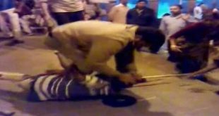 RPF personnel beating up a physically challenged person